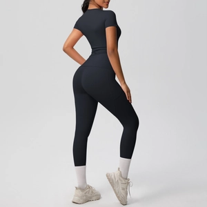 Rear view of tight black two-piece yoga set featuring high-waist leggings and slim top
