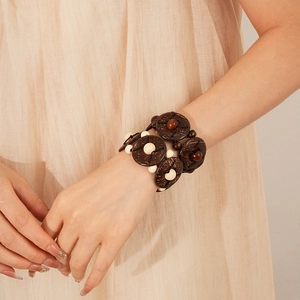 Detailed texture of geometric coconut shell and wooden beads on ethnic stretch bracelet