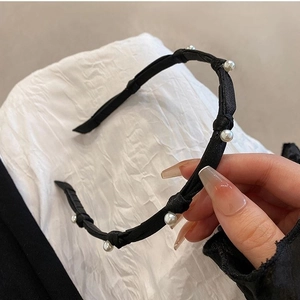 Elegant black thin headband with white pearls for women in a chic minimalist style