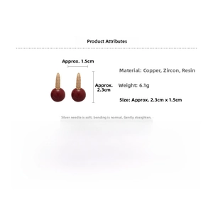 Detail view of red resin ball earrings with micro-paved zircon cone stud and silver pin