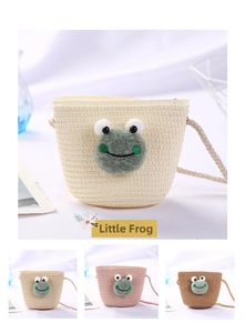 Detail of cute frog woven straw bucket bag for kids in white, khaki, pink and brown