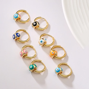 Gold-plated evil eye hoop earrings in various vibrant colors on a white background