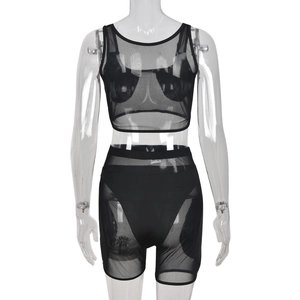 Detail of black mesh two-piece set featuring sleeveless crop top and slim fit shorts