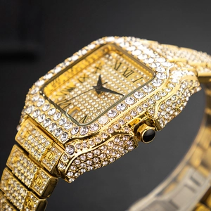 Macro side view of gold square iced out watch with Roman numerals and crystals