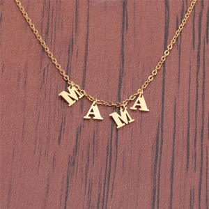 Golden stainless steel MAMA letter pendant necklace on a natural wooden background
