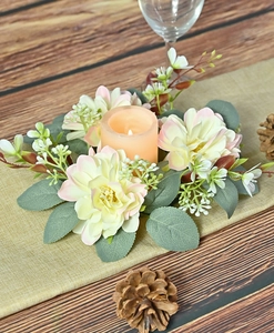 Floral candle ring with dahlias and eucalyptus leaves around an orange LED candle