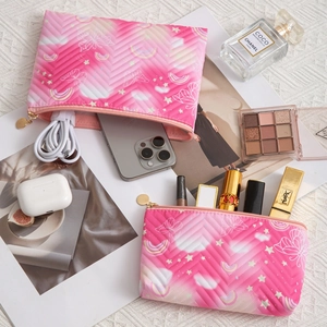 Quilted pink makeup bags with unicorn patterns and gold zippers for travel storage