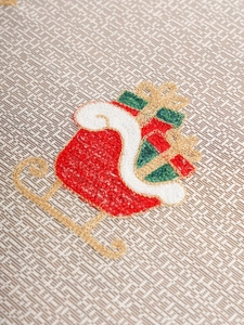 Detailed close-up of Christmas sleigh embroidery on premium woven polyester tablecloth