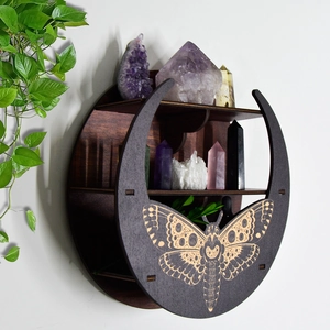 Detailed view of bohemian round wooden moon shelf with crystals and moth carvings
