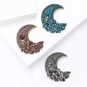 Three crescent moon alloy brooches with sparkling rhinestones in blue, magenta and grey black