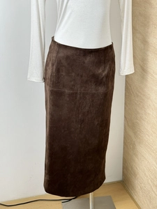 Detailed texture of dark brown faux suede midi skirt with side slit and slim H-line cut