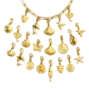 Flat lay of diverse gold-plated stainless steel charms featuring sea and animal motifs