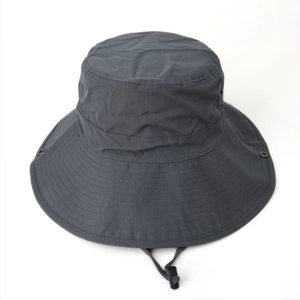 Close-up of wide brim sun hat with side snap buttons and adjustable windproof cord