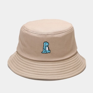 Detail of cute blue dinosaur embroidery on beige cotton canvas bucket hat