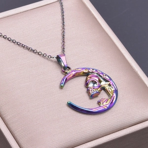 Macro shot of skull and moon pendant with rainbow metallic luster on jewelry cushion
