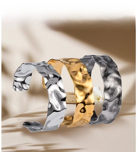 Detailed view of wide open cuffs with water ripple and hammered metal textures