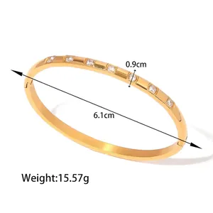 Macro detail of 18K gold wave bangle with white zircon inlays and side hinge clasp