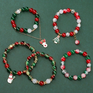 Detailed view of 5-piece Christmas beaded bracelets with reindeer and tree charms