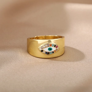 Detailed macro of gold-plated evil eye ring featuring vibrant colorful gemstones