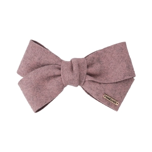 Elegant dusty pink bow hair clip in soft felt fabric with a gold handmade metal tag