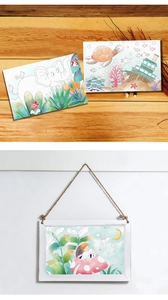 Detail of watercolor coloring cards set showing wall hanging and desk display