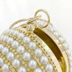 Luxurious spherical pearl evening bag with champagne gold rhinestones and ring handle