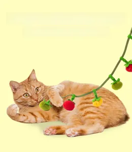 Detail of plush catnip persimmon toy with soft felt texture and hanging rope
