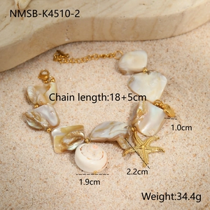 Detail of shell bracelet with golden starfish charms on beach sand, 18+5cm length
