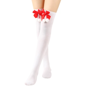 Detailed close-up of white over-the-knee socks with red satin bows and white pom-poms