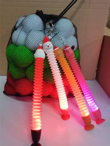 Detail showing glowing LED telescopic Christmas tubes with Santa toppers and suction bases