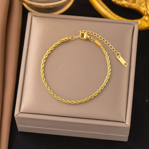 Detailed macro view of gold rope chain bracelet with lobster clasp and extender