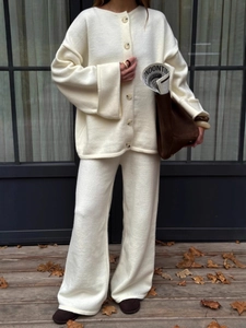 Women's cream knit two-piece set featuring a buttoned cardigan and wide-leg trousers