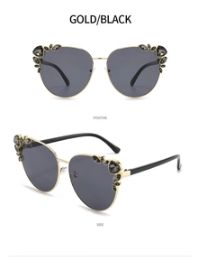 Detail view of gold cat-eye sunglasses with rhinestone accents and dark black lenses