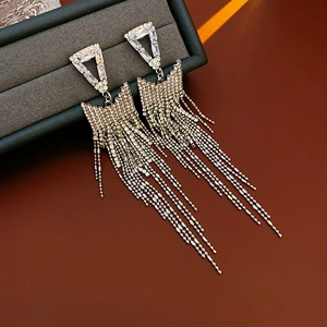 Close-up of sparkling triangle rhinestone tassel earrings with silver base in a gift box