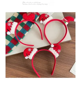 Detailed view of Christmas headbands with sequined hearts and festive mini Santa hats