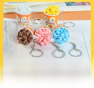 Detailed close-up of mini popcorn bucket keychains in multiple vibrant colors