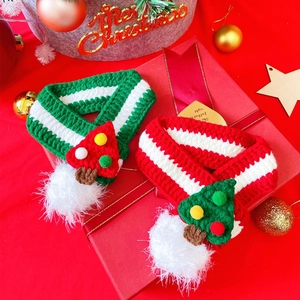 Knitted Christmas pet scarf with tree and mushroom decor on red festive gift box