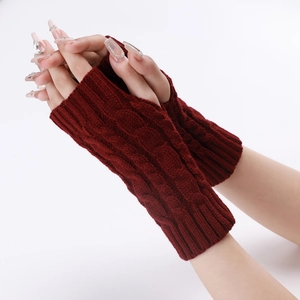 Close-up of cable knit burgundy fingerless gloves showing thick texture and warm arm sleeves