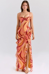 Detail of bohemian chiffon dress with vibrant orange print and side lace-up design
