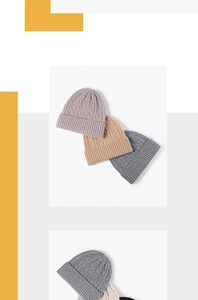 Detailed view of cable knit merino wool beanies showing various neutral color textures