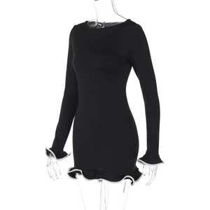 Detail of black long sleeve mini dress featuring white trimmed ruffles and elastic fabric