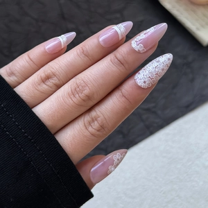 Elegant long almond press-on nails with pink purple gradient, lace flowers, and pearls