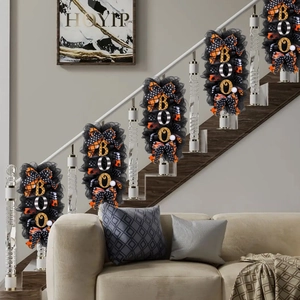 Set of 5 black mesh Halloween BOO wreaths with orange ribbons on staircase railing