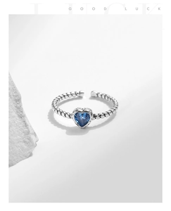 Detailed macro view of S925 silver ring with blue heart zircon and twisted rope band