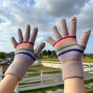 Detailed close-up of grey knitted touchscreen gloves with vibrant rainbow striped cuffs