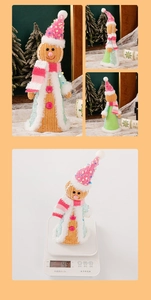 Detailed close-up of a gingerbread man plush toy with festive sequins and a striped scarf
