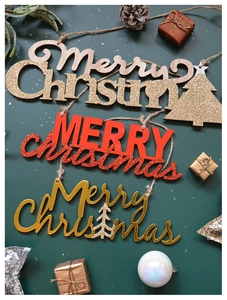 Detail of wooden Merry Christmas hanging signs with gold glitter and red festive accents
