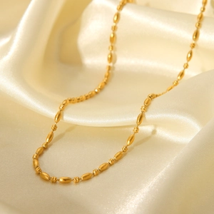 Minimalist 18K gold plated stainless steel oval bead chain necklace on champagne silk