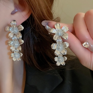 Elegant silver triple-layered flower drop earrings with fine brushed metallic texture