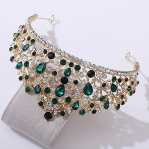 Macro shot of luxury bridal tiara with green pear-shaped gems and shimmering rhinestones